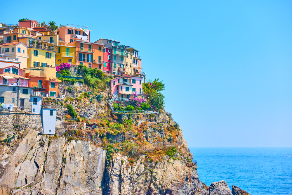 Small italian town with colorful buildings on the rock by the sea, Manarola, Cinque Terre, Italy. Copyspace composition