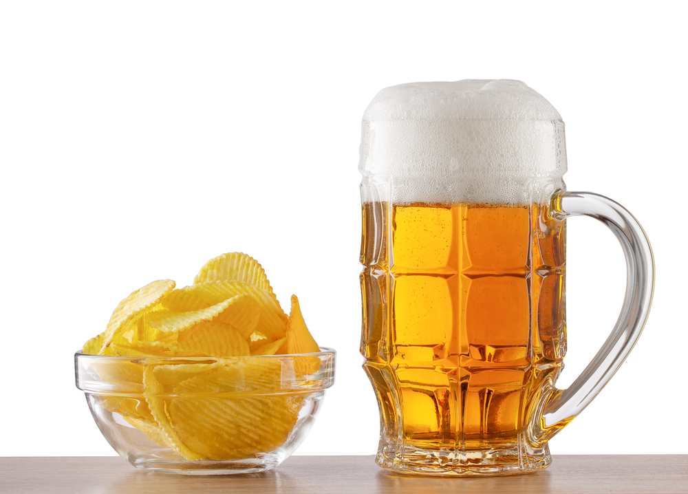 Bar counter with a glass of beer and a plate of chips isolated on white background. Bar counter with glass of beer and plate of chips