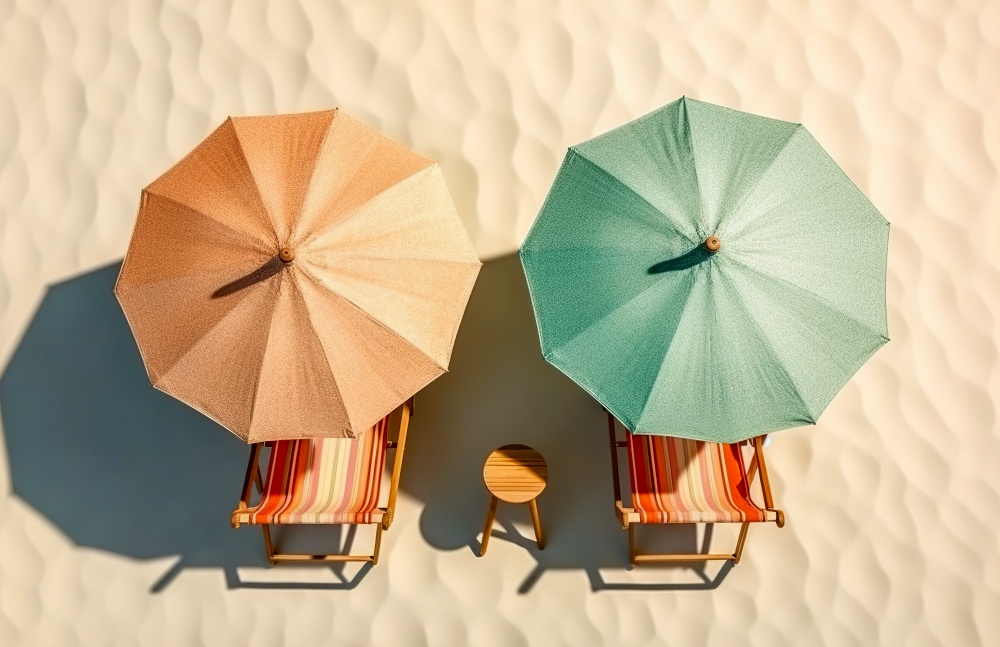 Two beach umbrella and deck chairs on stunning tropical beach sand. Summer vacation background. Created with generative Ai technology.