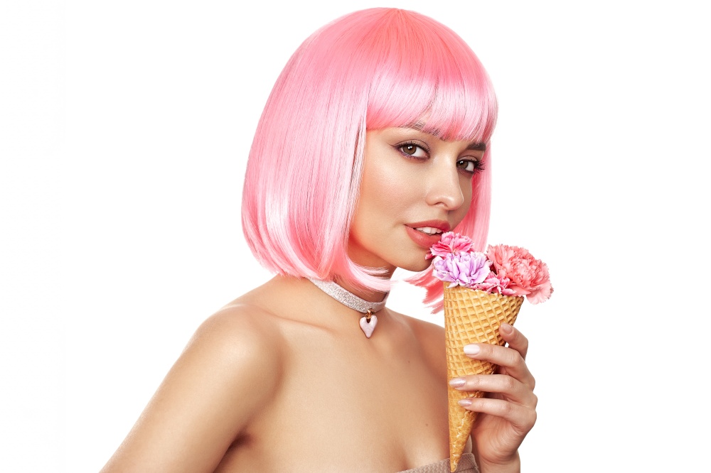 Beauty model portrait with pink hair. Bob short Haircut. Beautiful glamorous girl with flower ice cream