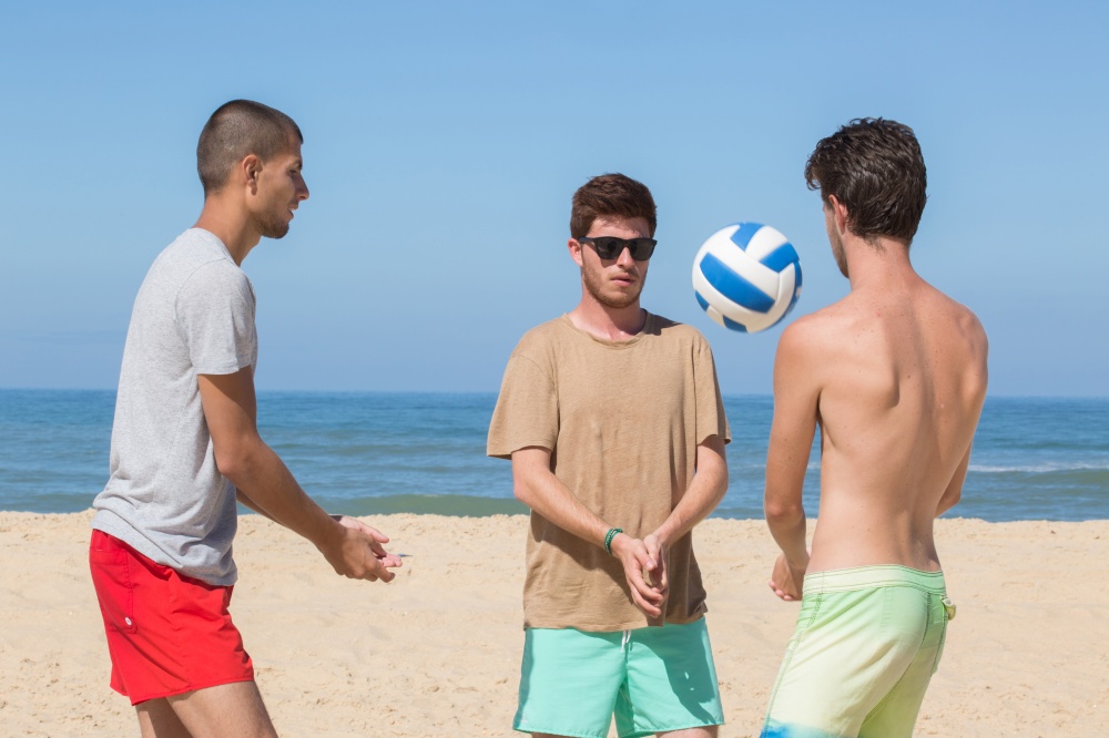 group of friends playing beach volley