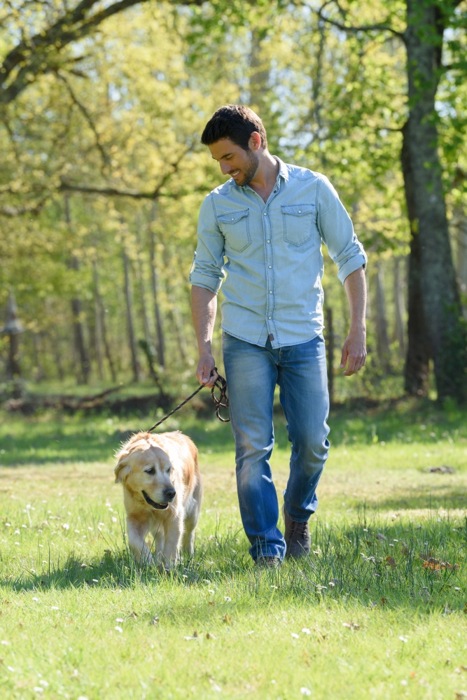 man walking a dog in the park