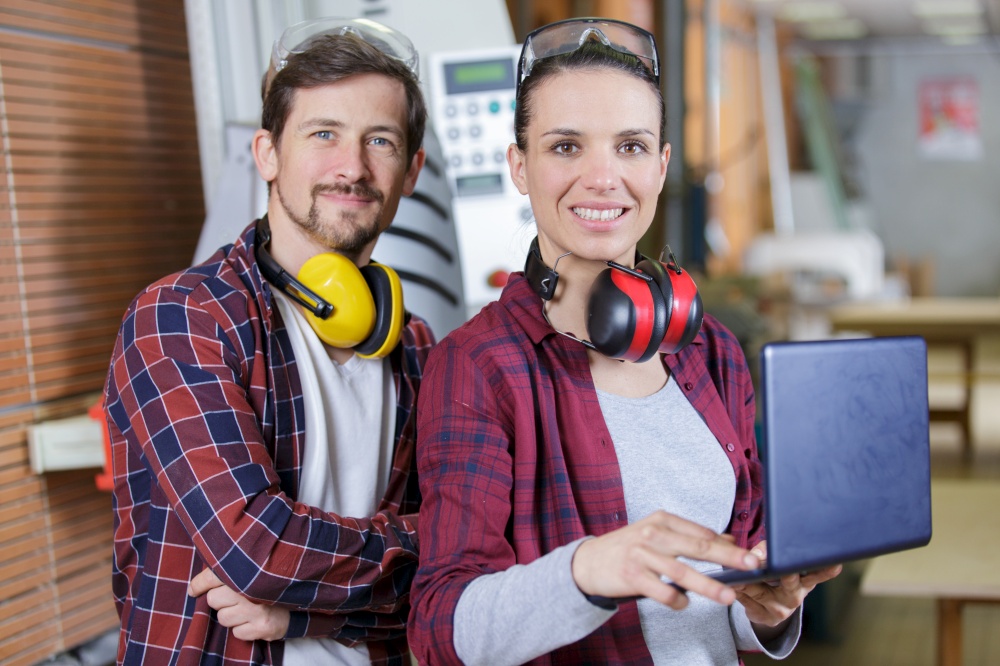 couple in uniform working at carpentry