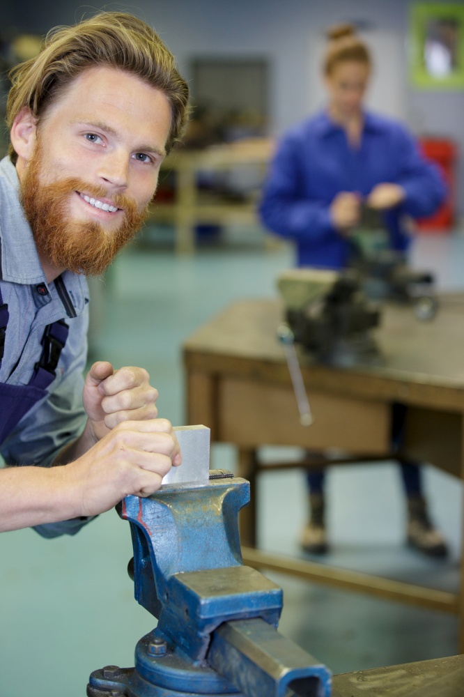 bearded male worker smiling and looking at camera