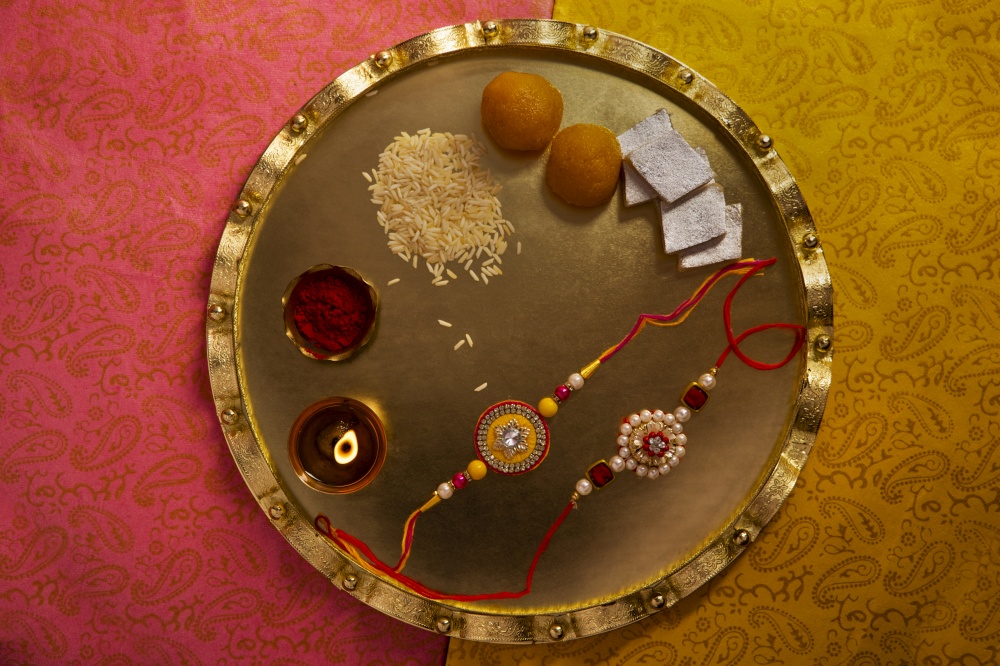 Decorative thali filled with rakhi and sweets on the occasion of Rakshabandhan