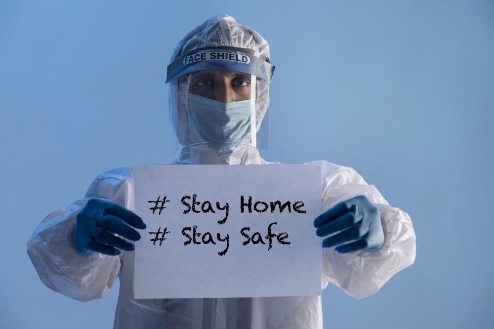 Doctor holding a sign of stay at home in his hands