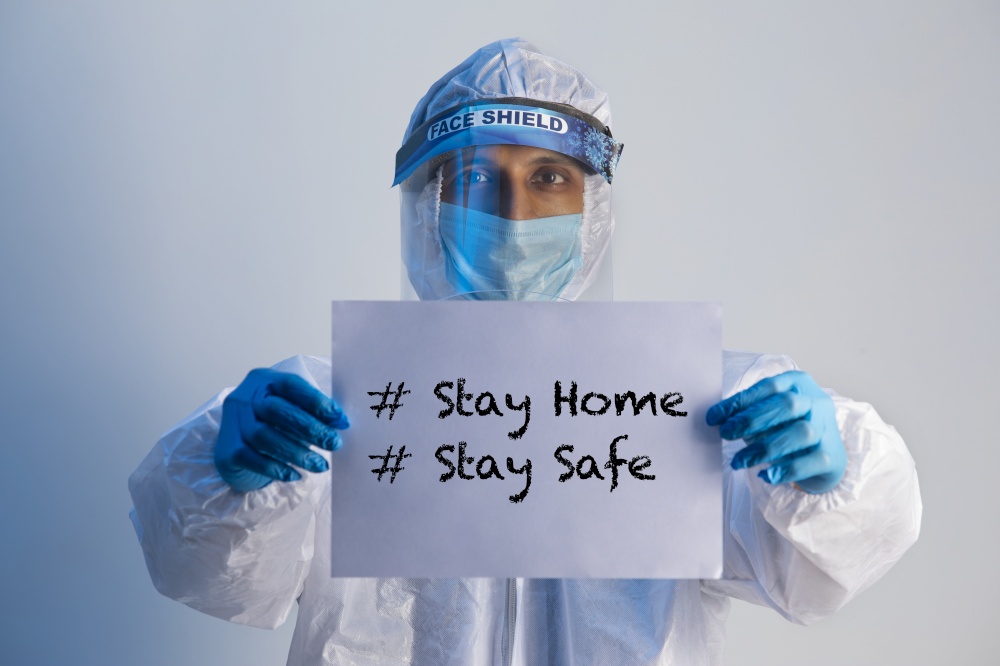 Doctor holding a sign of stay at home in his hands