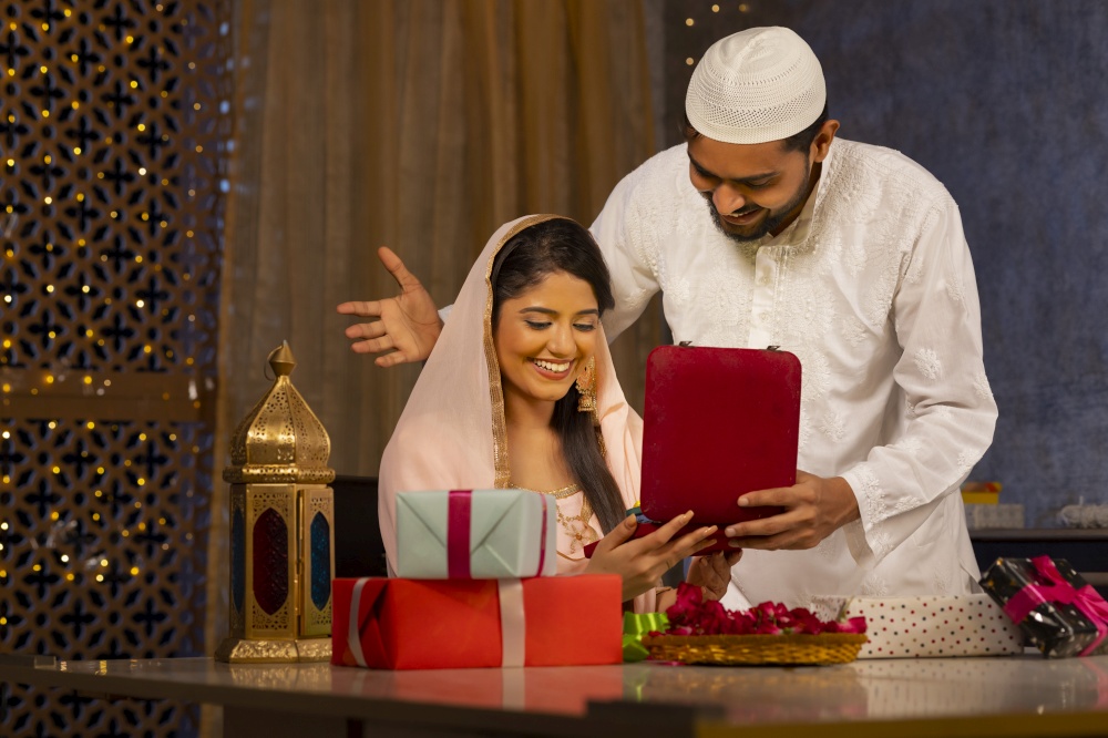 Muslim man giving  gift to his wife during Eid-Ul-Fitr