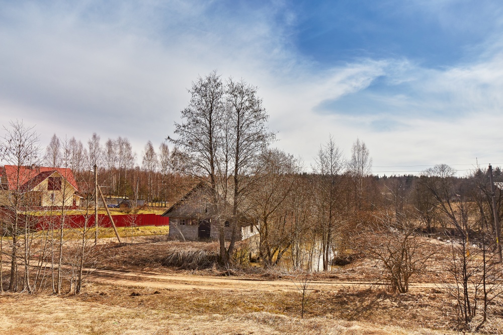 Ruins of old water mill at springtime. March spring day. Calm weather. Season change. Village rural landscape. Belarus.