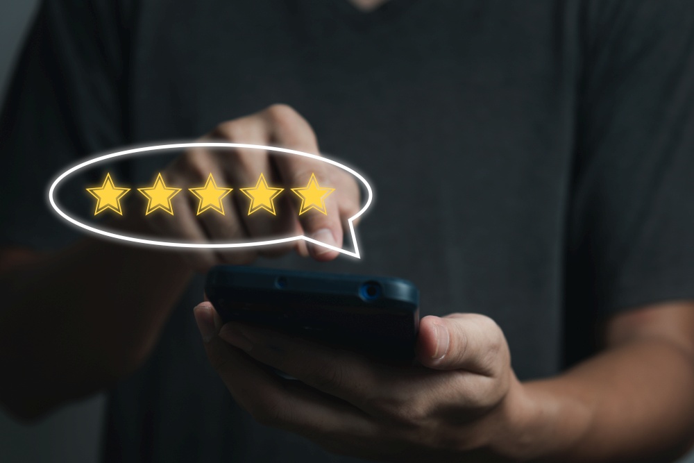 businessman hand using smart phone and give five star symbol icon for feedback review satisfaction service rating of product. Satisfaction Concept.