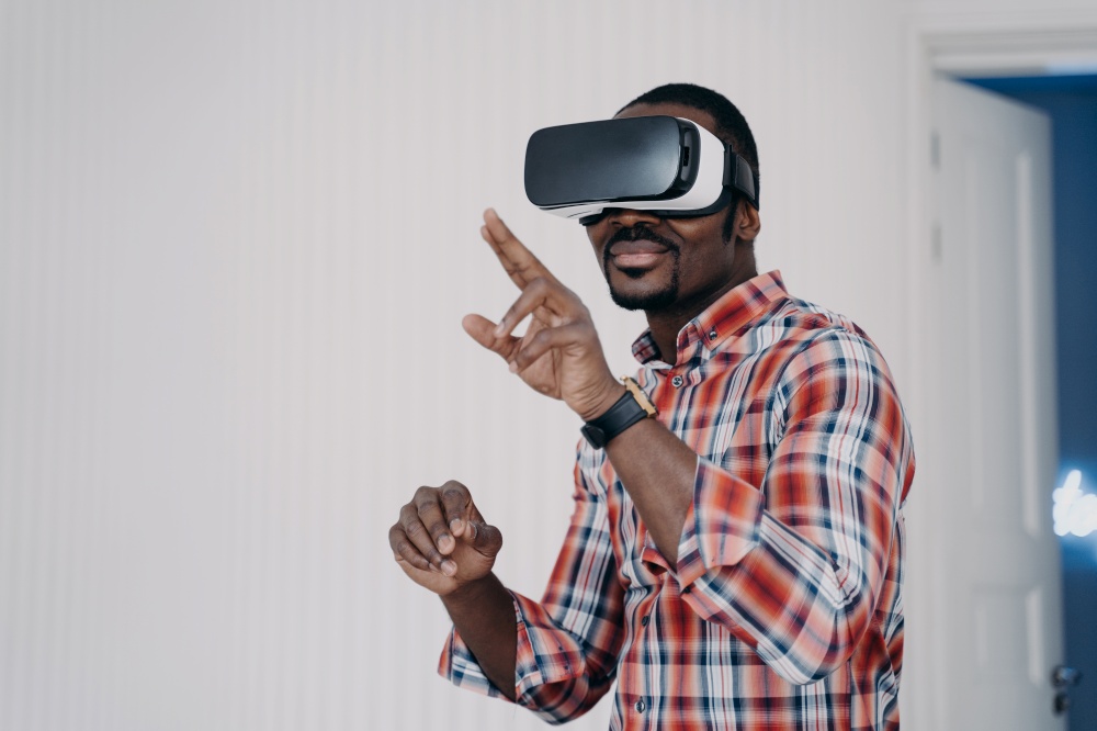 African american man wearing virtual reality glasses, testing purchase, shopping in cyberspace. Modern black guy in vr goggles playing video game, interacting with virtual objects, enjoying high tech.. African american man in virtual reality glasses testing purchase, shopping in cyberspace. E commerce