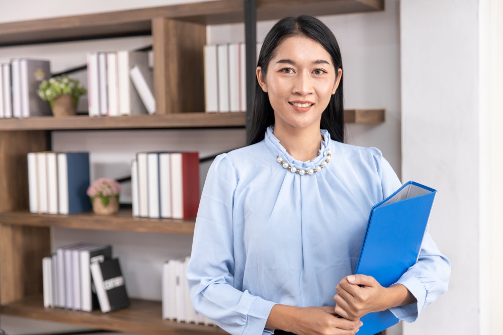 Asian business female women adult employee for accountant secretary or HR manager handle file folder. Portrait Thai middle age lawyer office worker professional look.
