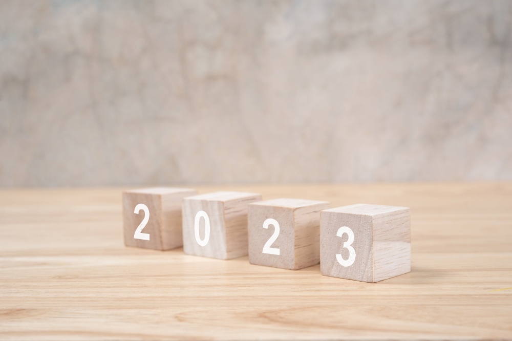 2023 happy new year on wood block on wooden table and background. new year concept.