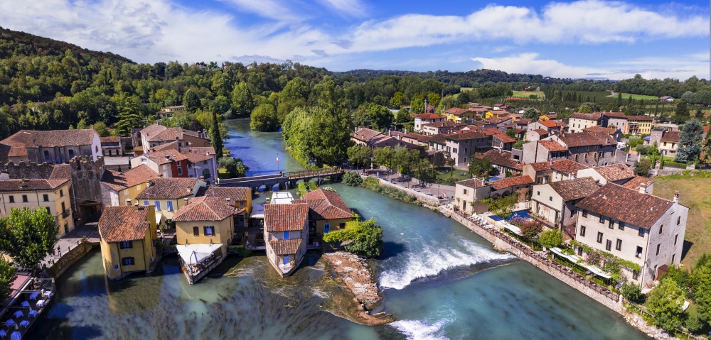 Borghetto sul Mincio aerial view. one of the most beautiful medieval villages of Italy. colorful houses located in the middle river and waterfalls. Verona province, near Garda Lake