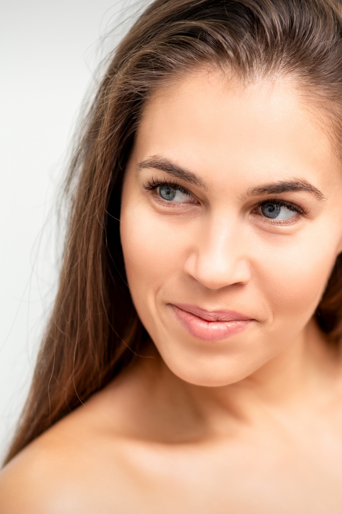 Face portrait of young caucasian woman with naked shoulders and natural make up on white background. Face portrait of young caucasian woman