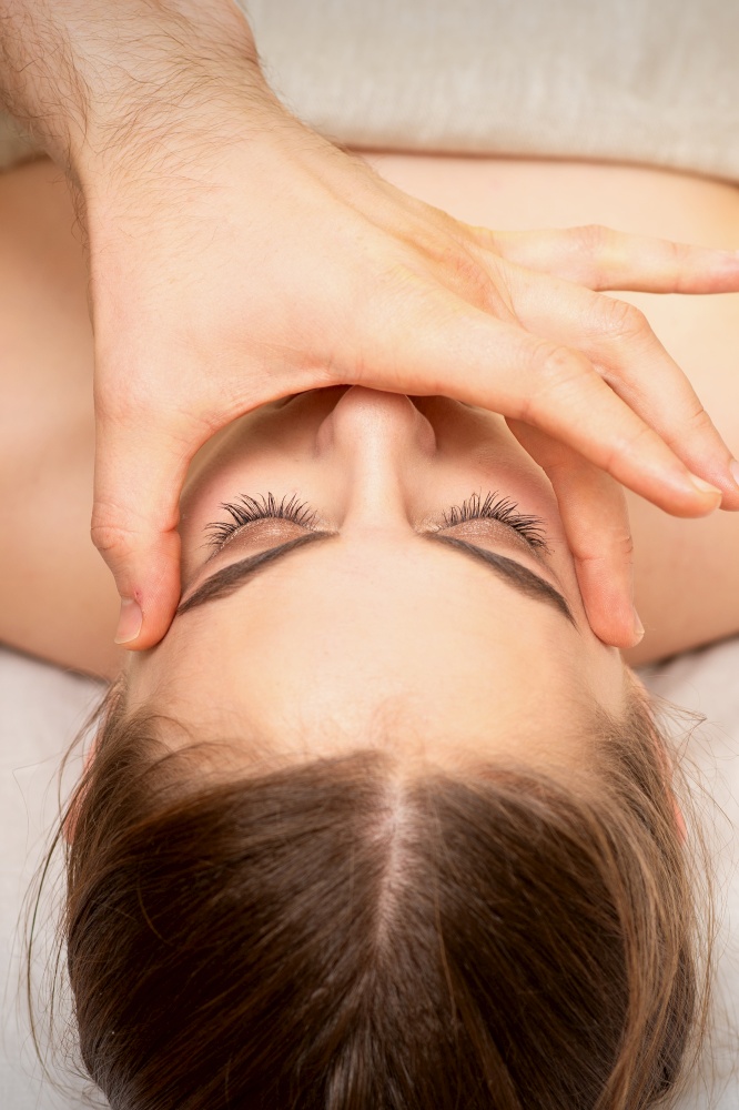 Face massage with fingers of a masseur. Female facial skin care at a beauty spa salon. Face massage with fingers of a masseur. Female facial skin care at a beauty spa salon.