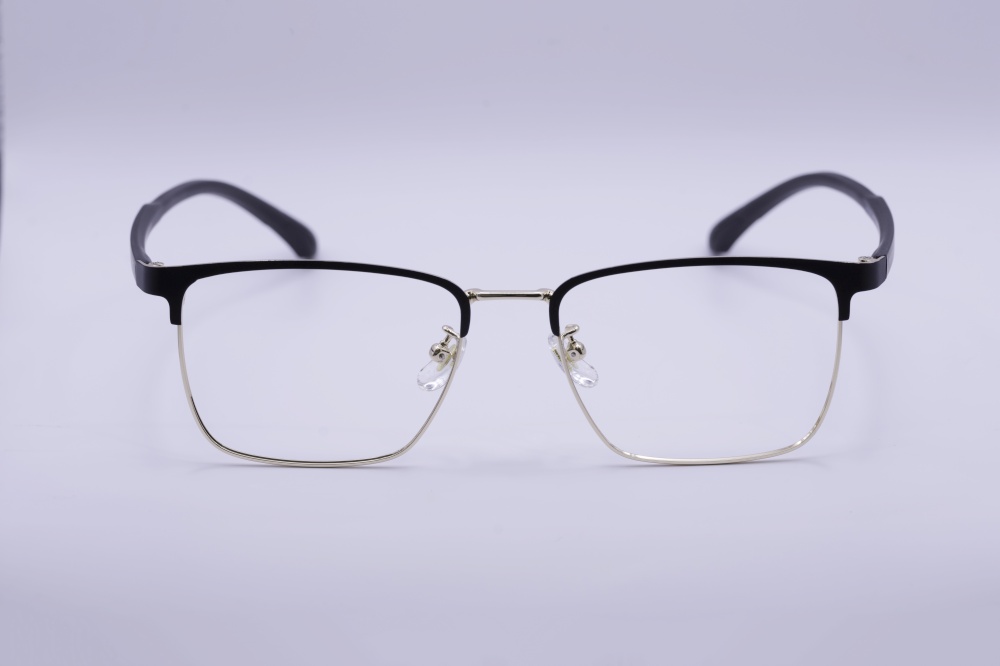Eyeglass frames, lenses, various colors, both metal and plastic, on a beautiful colored background.
