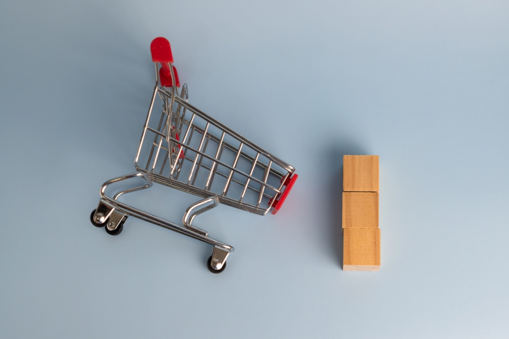wood block cube blank and shopping cart on background.Promotion marketing business commerce sale.