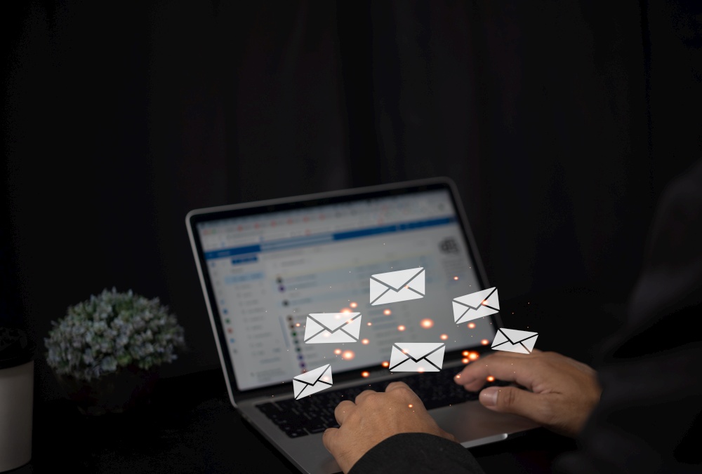 Send contacts Mail Communication Connection message to mailing Letters Concept computer browsing.Man hand typing on laptop keyboard with envelope icon.