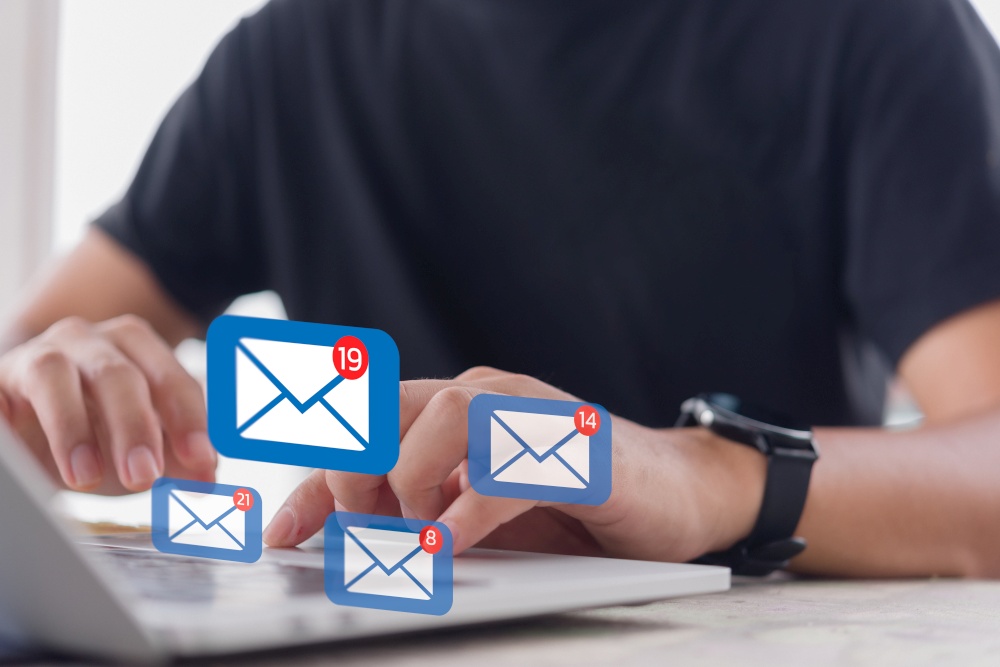 Man checking email icon online or sending mail to partner and customer on web with virtual interface technology concept.