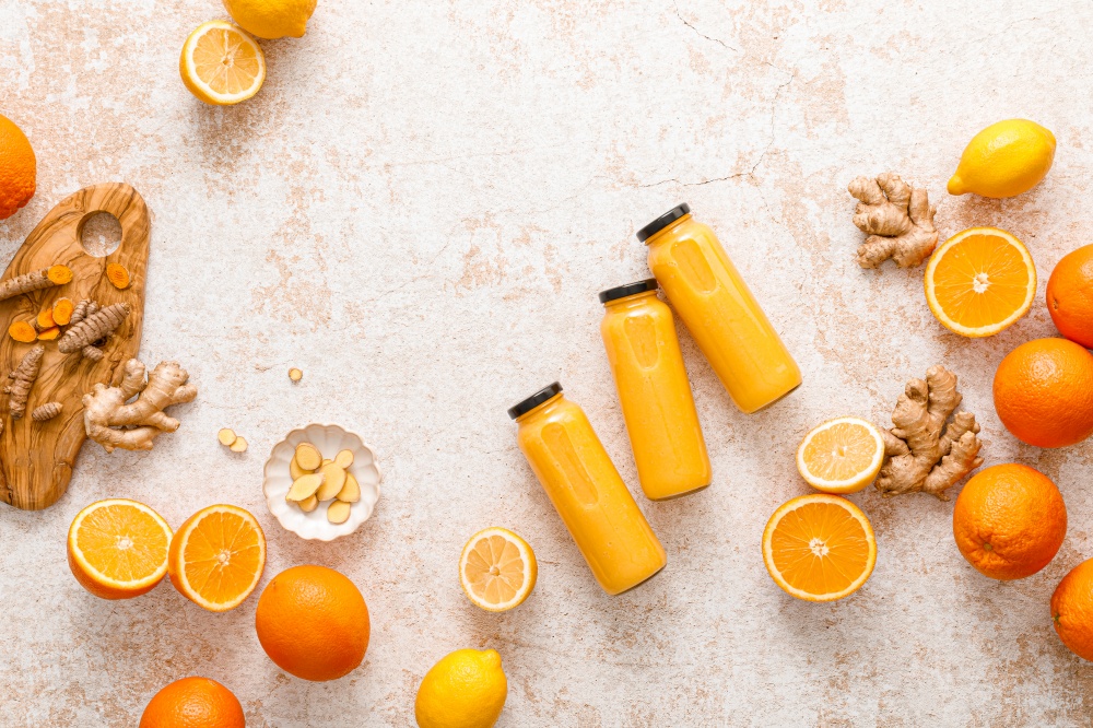 Smoothie. Healthy fresh raw detox citrus smoothie with orange, lemon, ginger and turmeric in a glass bottles on a table. Healthy diet vegan food full of antioxidants