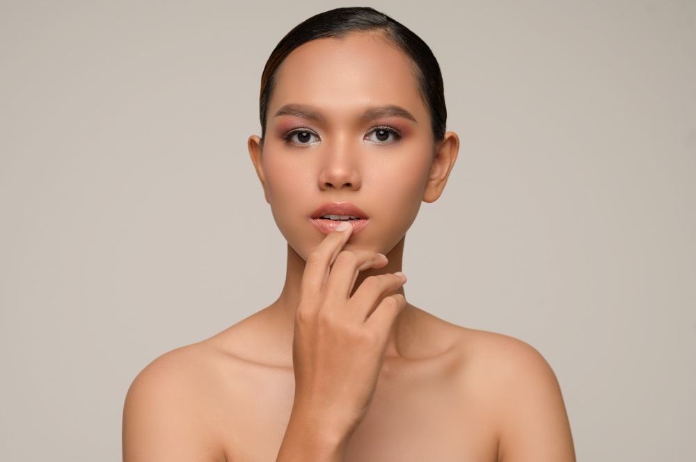 Portrait with manicure hands of beautiful asian woman touch mouth, beautiful natural clean skin nature make up,  fresh spa female beauty cometic, copy space