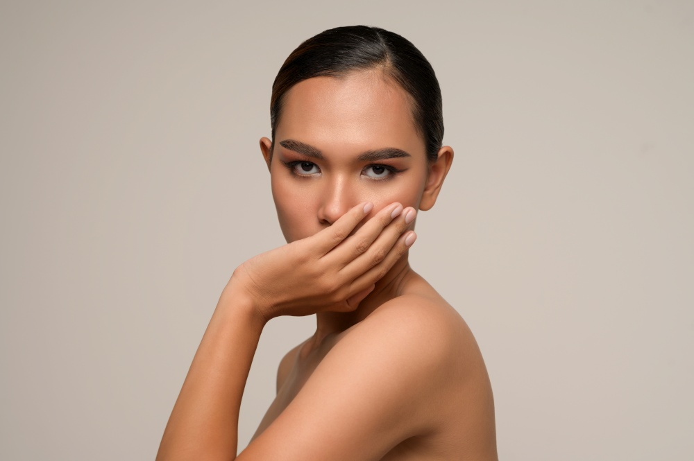 Portrait with manicure hands of beautiful asian woman pose with cover her mouth, beautiful natural clean skin nature make up,  fresh spa female beauty cometic, copy space