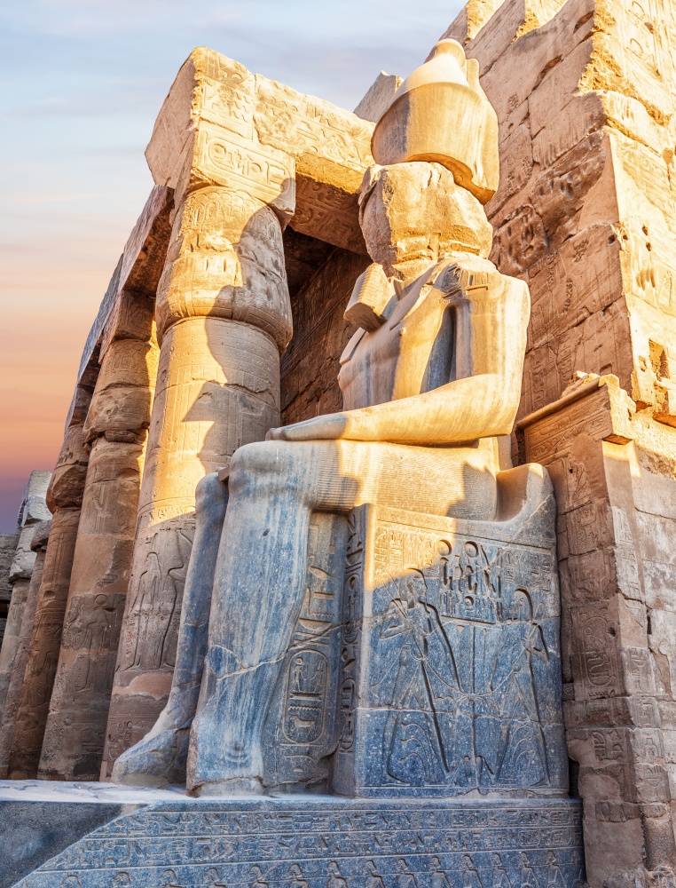 Seated Rameses II Statue at the entrance of Luxor Temple, Egypt.