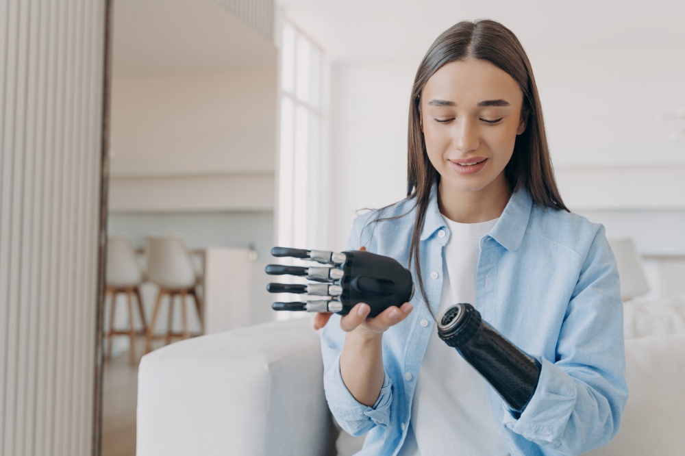 Disabled woman assembles bionic arm with hand. Prosthesis connects at wrist joint.