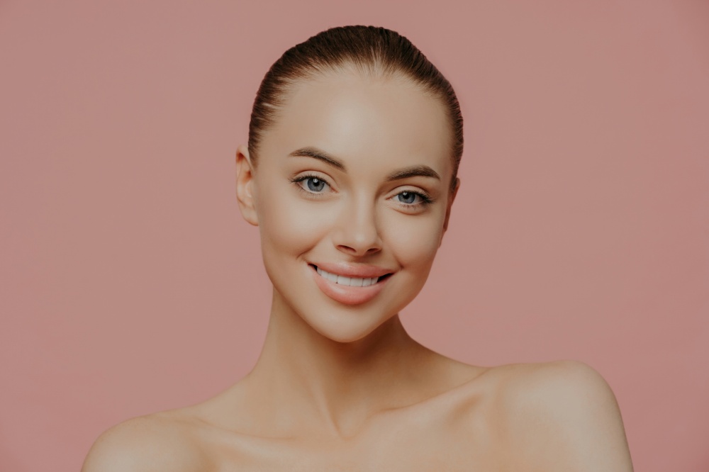 Beautiful model with clean skin, smiling, isolated. Cosmetology concept.