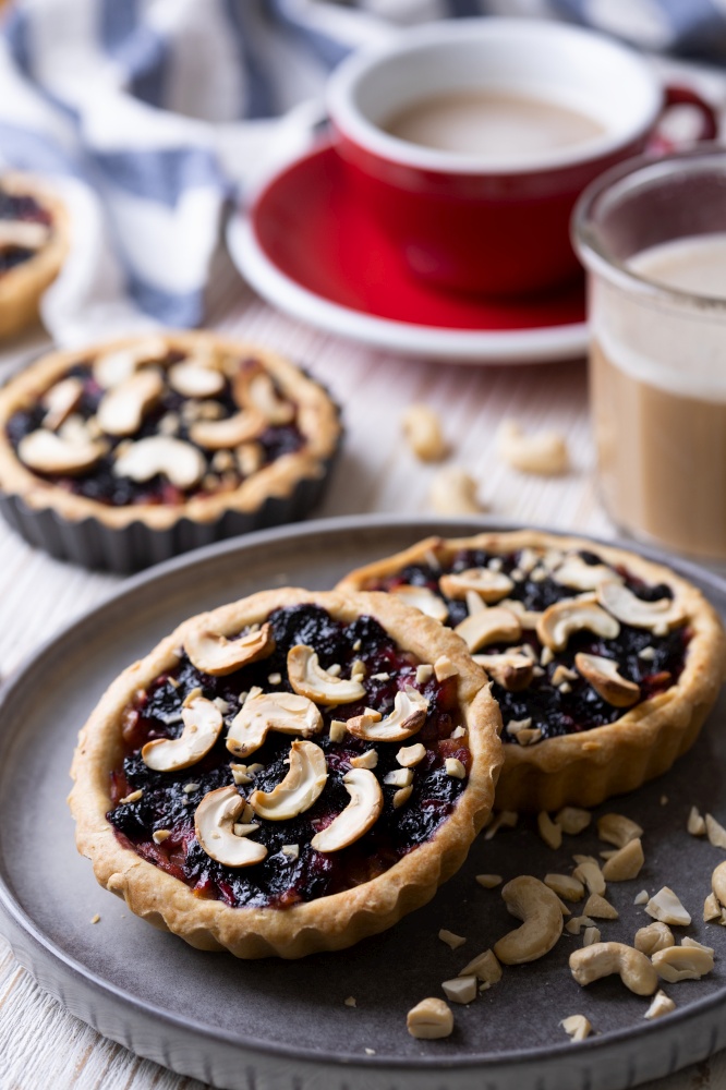 tartlets with apple jam and blueberry confiture with cashew nuts