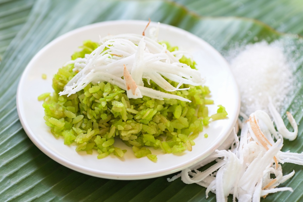 Thai dessert - pounded unripe rice food rice flakes cereal with coconut and sugar, Green rice sweet with ears of rice pandan leaf, Food dessert or snacks