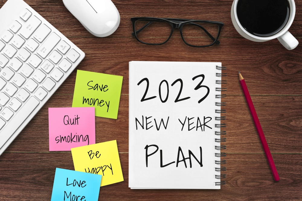 2023 Happy New Year Resolution Goal List and Plans Setting - Business office desk with notebook written about plan listing of new year goals and resolutions setting. Change and determination concept.. 2023 Happy New Year Resolution Goal List and Plans Setting