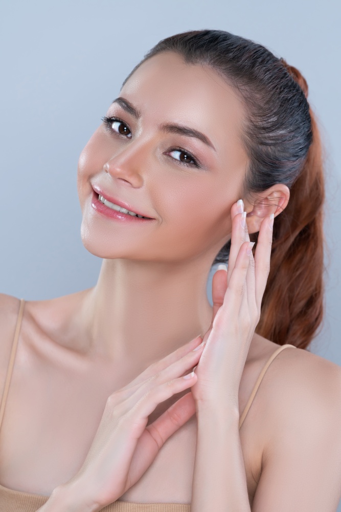 Closeup glamorous beautiful perfect clean skin soft makeup woman finger applying moisturizer cream on her face under contour eye for anti aging wrinkle. Facial skin rejuvenation in isolated background. Closeup glamorous woman applying moisturizer cream on her face for perfect skin