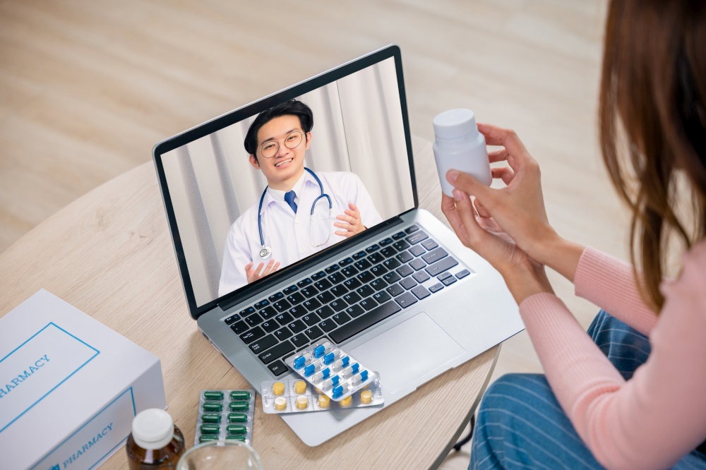 Telemedicine. Young female sick she video call online consultation with doctor consulting about illness and medication with laptop computer, Method of taking the drug, medical support