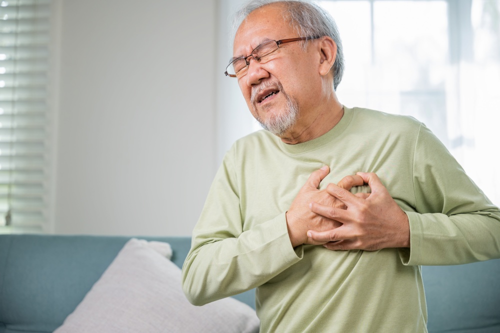 Asian older man have congenital disease suffering from heartache alone at home, Senior man bad pain hand touching chest having heart attack, Old age retirement health problems unhealthy diseased