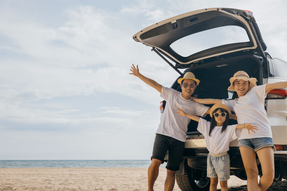 Parents and child traveling in holiday at sea beach, family having fun in summer vacation on beach blue sky, People enjoying road trip stand on back their car raise arms and hand up, Happy Family Day