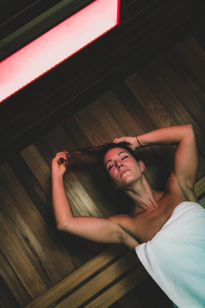 Woman Relaxing in Hot Sauna.. Woman in Sauna