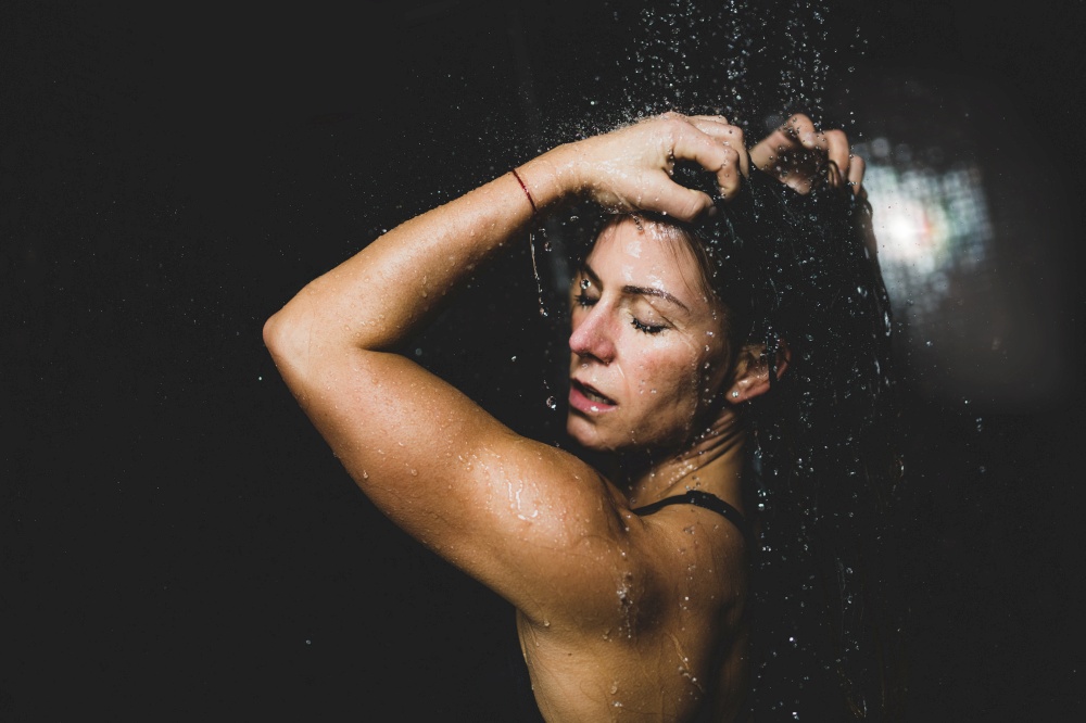 Beautiful Woman Taking a Shower after Spa Center Sauna.. Woman Under the Shower