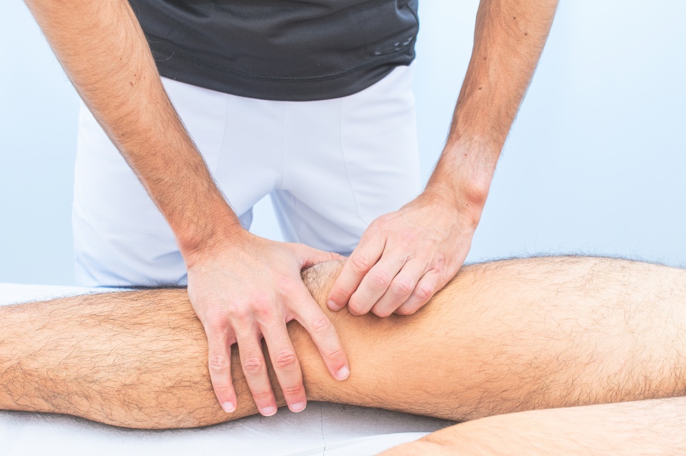 Knee patella mobilization by a physical therapist in studio