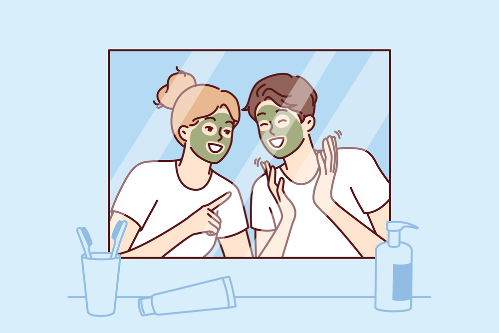 Cheerful couple with rejuvenating mask on faces look in mirror and laugh enjoying joint vacation. Morning young happy man and woman with mask for rejuvenation and removal of wrinkles from face. Cheerful couple with rejuvenating mask on faces look in mirror and laugh enjoying joint vacation