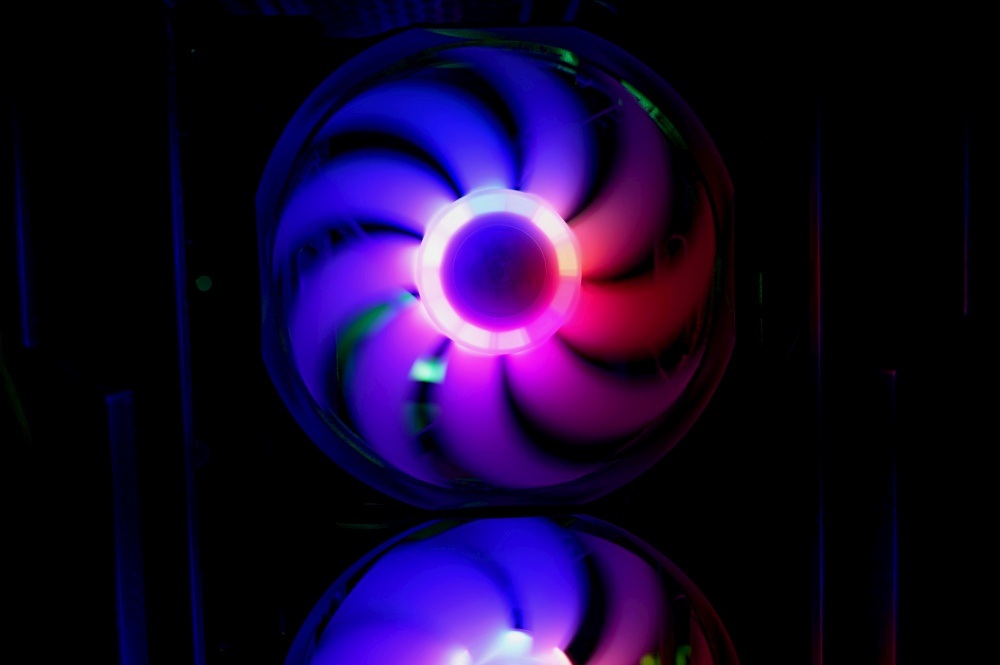 Colorful bright rainbow led rgb pc fan air case cooler. Computer chassis. Gaming modding, technology concept and IT background.