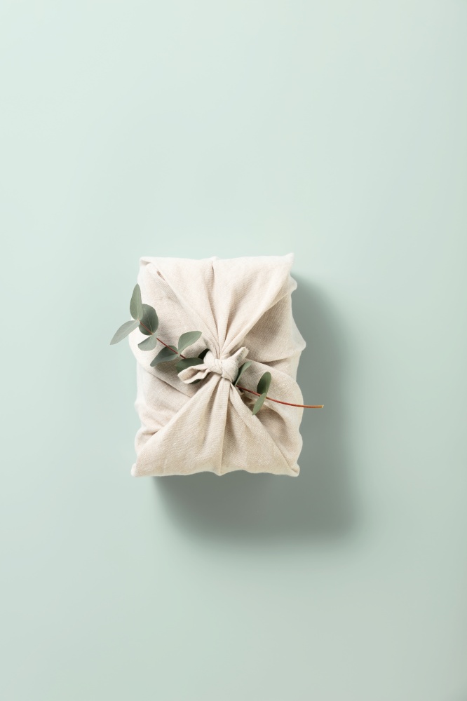 Eco-friendly reusable gift textile packaging with eucalyptus. Sustainable gift wrapping. Zero waste