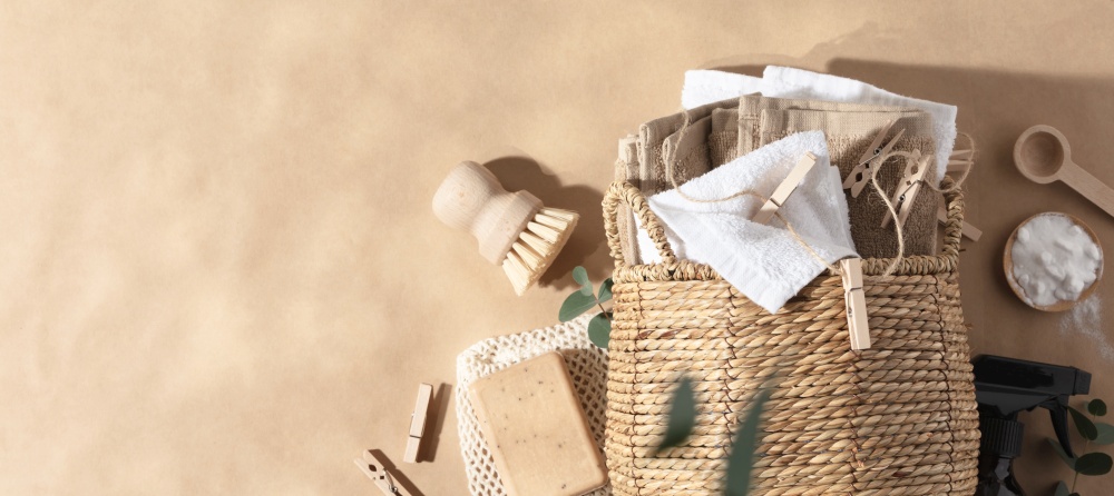 Straw wicker basket with natural cotton fabric and Ingredients DIY - soap bar and baking soda, space for a text banner. Eco-friendly laundry and housekeeping concept banner copy space