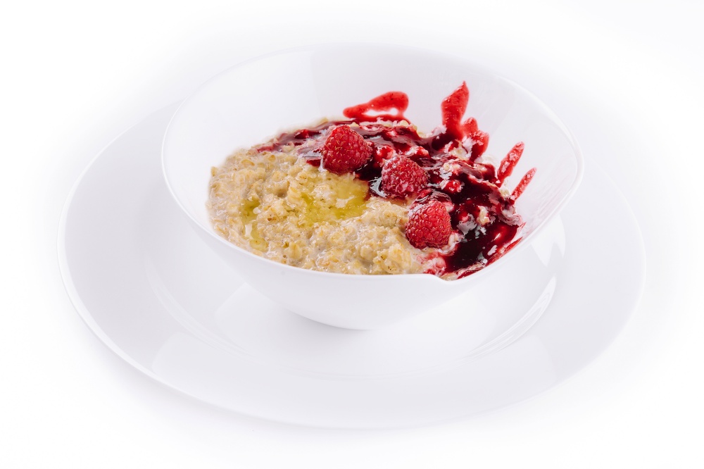 Oatmeal rustic porridge with raspberries jam