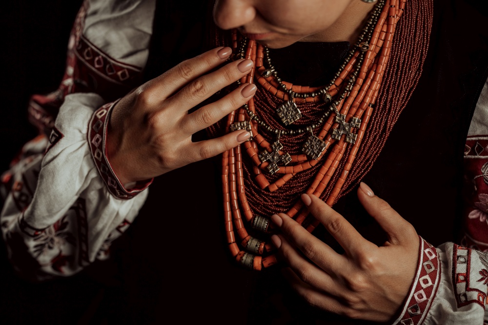Demonstrating traditional antique jewelry necklace. National costume of Ukraine. Ukrainian woman in legacy ancient coral beads, Zgarda - archaic hutsul neck ornament of status religious purpose.. Ukrainian woman in legacy ancient coral beads, Zgarda. Authentic traditional.