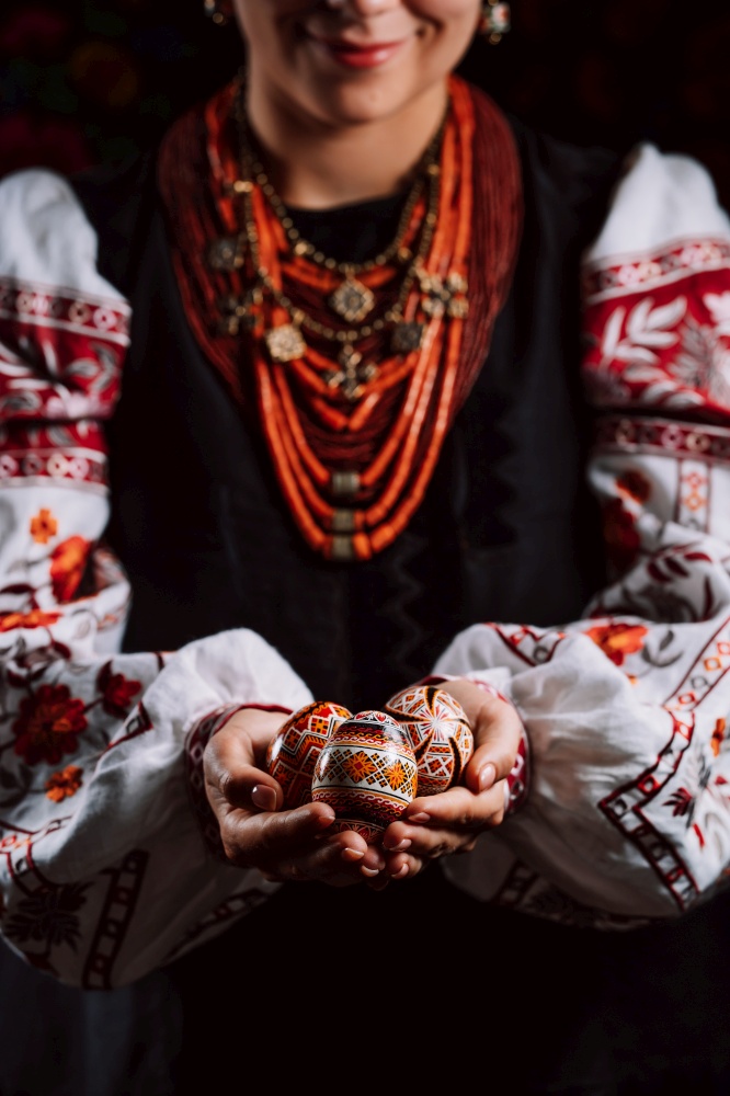 Ukrainian woman hand painted Easter eggs. Beautiful geometric slavic decoration. Lady in embroidery vyshyvanka dress. High quality photo. Ukrainian woman hand painted Easter eggs. Geometric slavic decoration ornaments