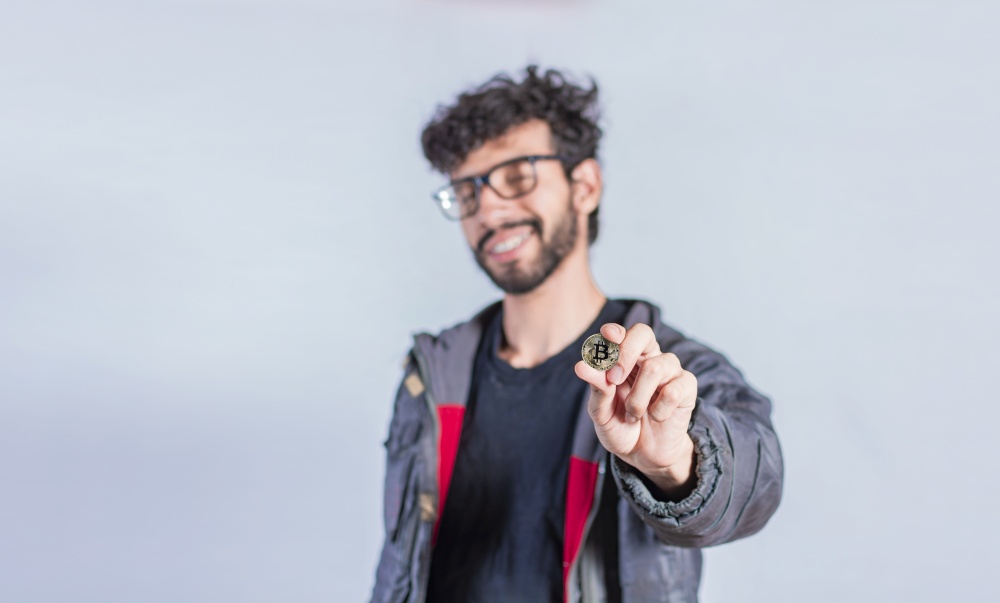 Smiling man holding bitcoin coin, Handsome man showing bitcoin coin, Person holding bitcoin coin isolated