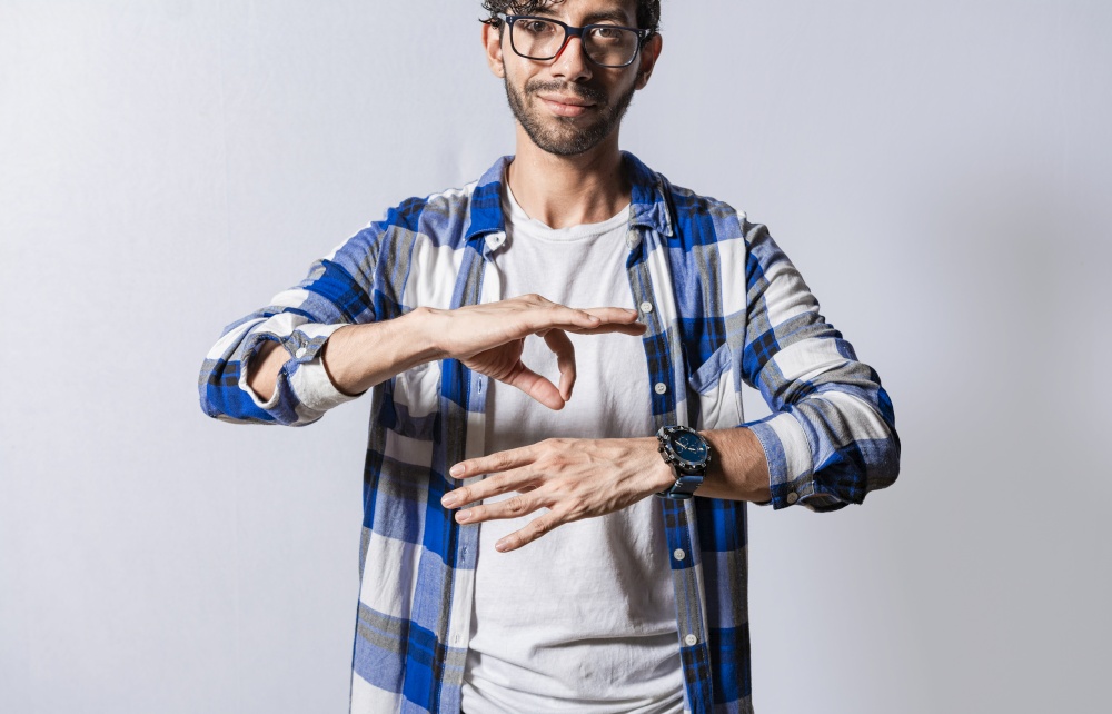 Young man gesturing in sign language, People who speak in sign language. Manual gestures of people with hearing problems, Person speaking in sign language isolated