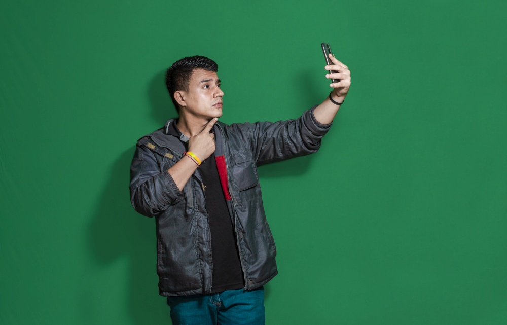 Guy taking photo isolated, man taking some selfie with isolated background